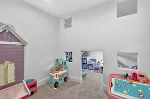 Playroom with carpet floors and baseboards