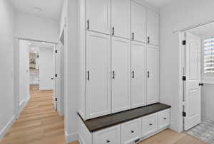 Mudroom featuring light wood-style flooring and recessed lighting
