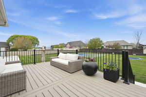 Wooden deck with a residential view and outdoor furniture