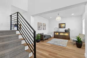 Entryway with light wood-style floors and recessed lighting