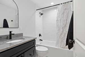 Full bath featuring vanity, shower / tub combo with curtain, and recessed lighting