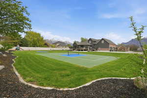View of community featuring a mountain view, a pickleball court, and a residential view