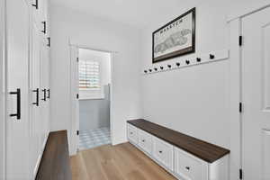 Mudroom featuring light wood-type flooring