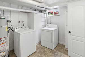 Laundry area with water heater and independent washer and dryer