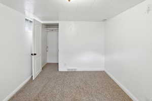 Unfurnished bedroom with a closet and light colored carpet