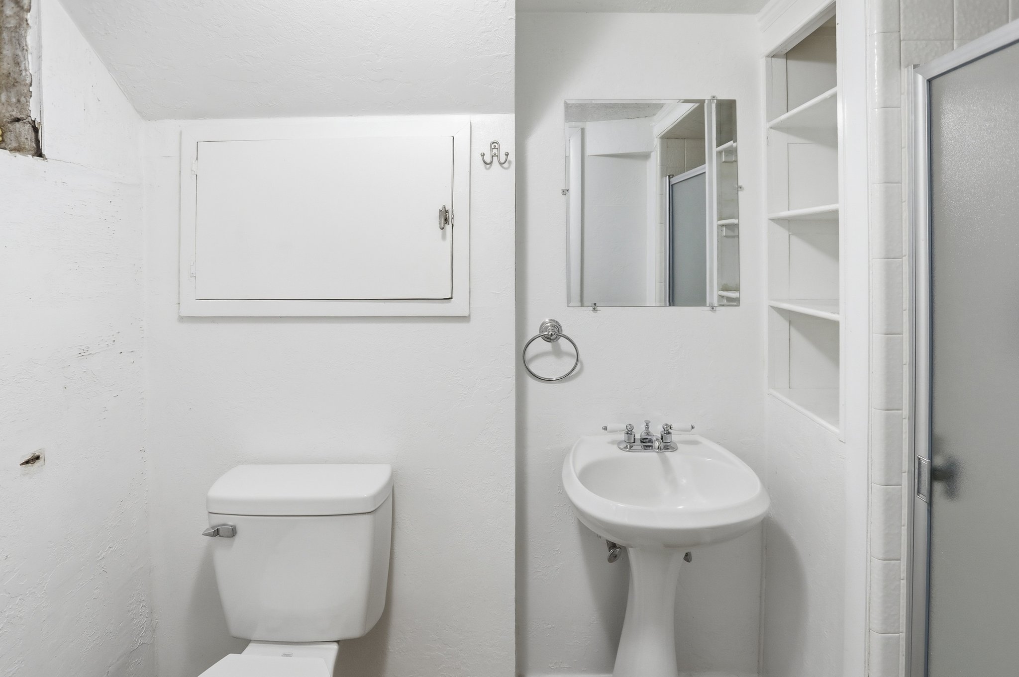 Full bathroom featuring toilet and a shower stall