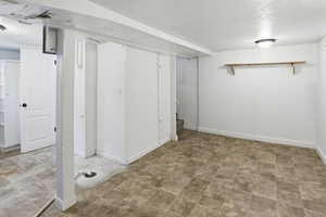 Finished basement with baseboards and stone finish flooring