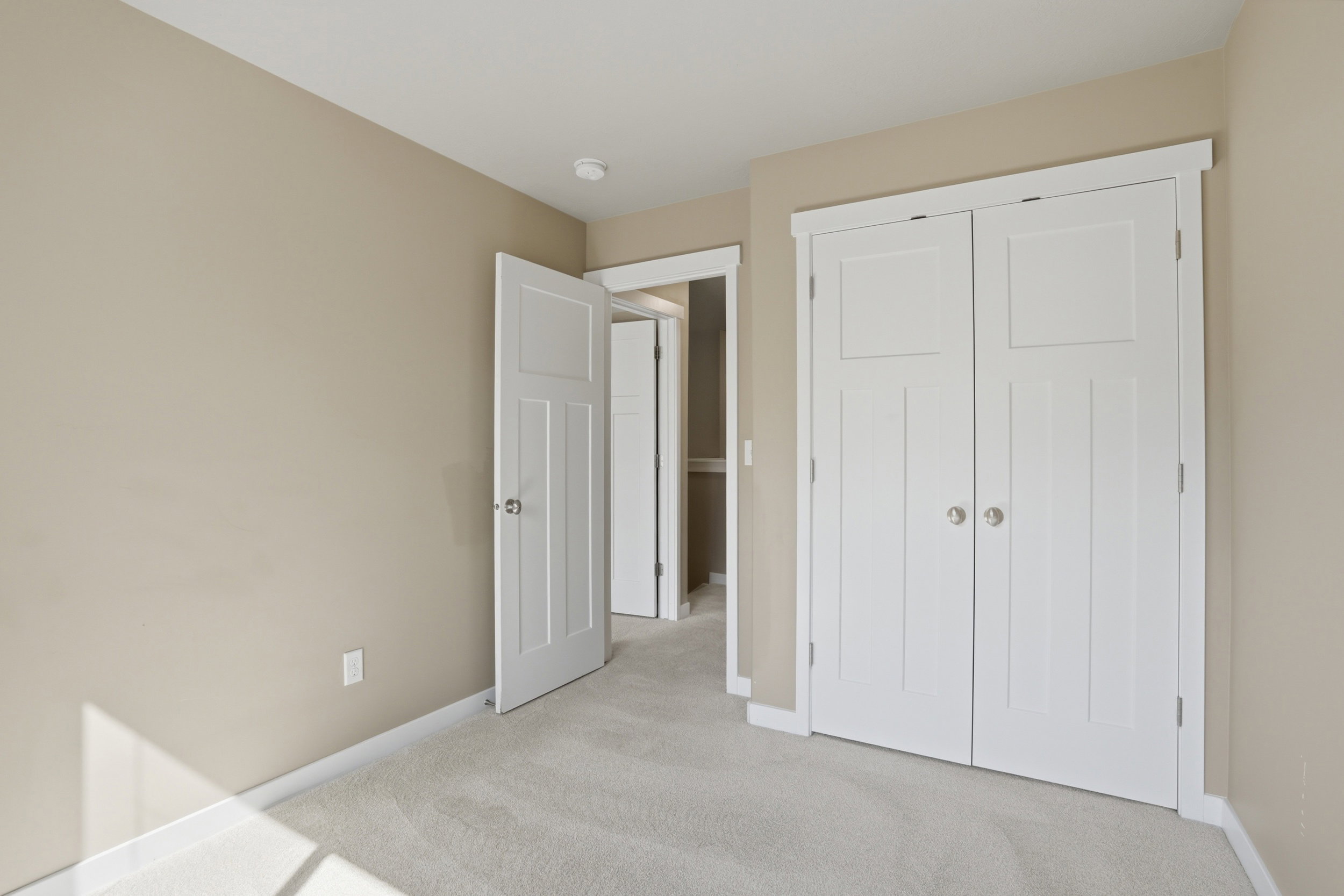 Unfurnished bedroom featuring light carpet and a closet