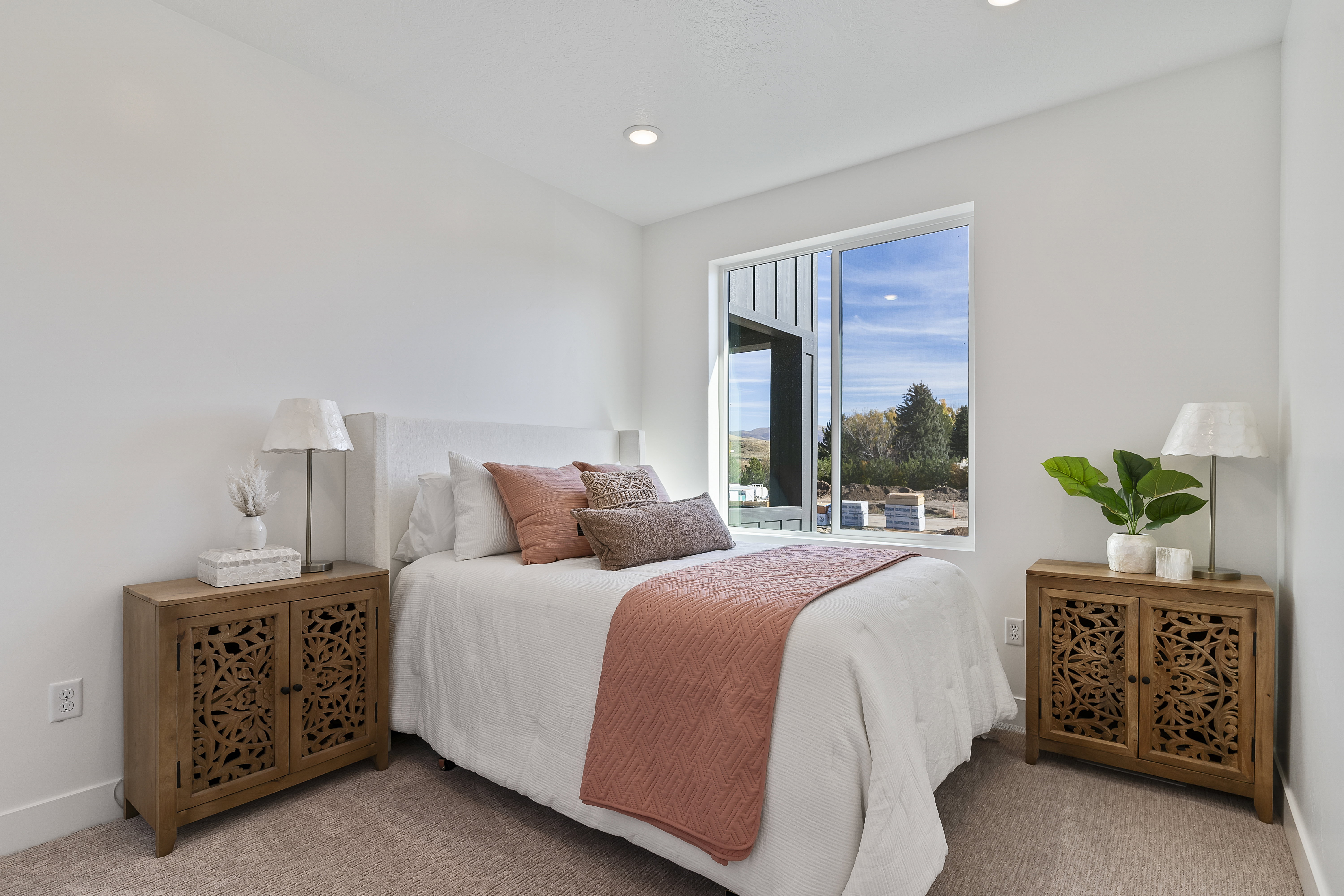 Bedroom with light carpet and baseboards