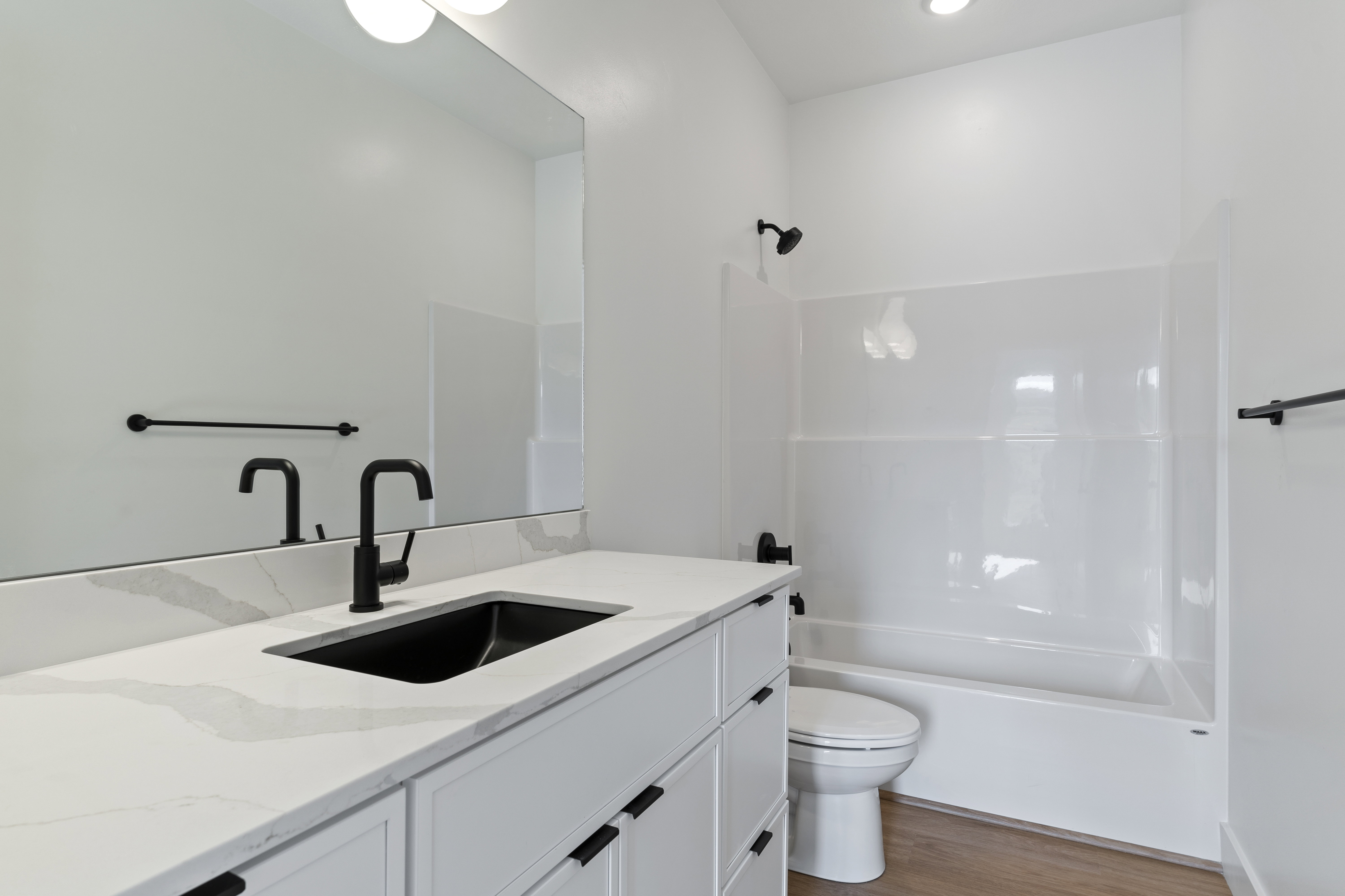 Bathroom featuring vanity, light wood-type flooring, and shower / tub combination