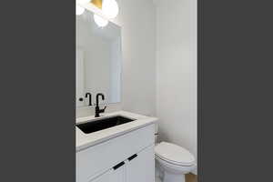 Half bath featuring vanity and toilet