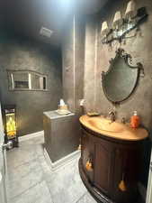 Bathroom with vanity and baseboards