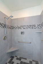 Full bathroom featuring a tile shower
