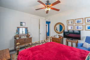Bedroom featuring ceiling fan and baseboards