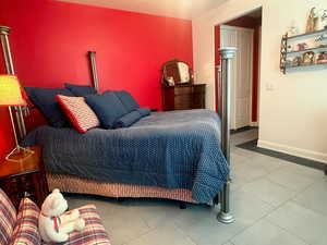 Bedroom featuring baseboards and light tile patterned floors
