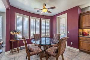 Dining room with ceiling fan and light tile patterned floors