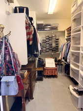 Walk in closet with light tile patterned flooring