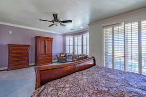 Bedroom featuring access to exterior, ornamental molding, a ceiling fan, recessed lighting, and a textured ceiling