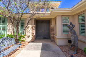 Doorway to property featuring stone siding