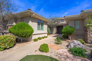 Property entrance featuring stucco siding and a tiled roof