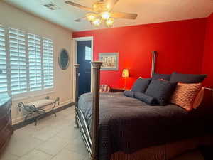 Bedroom featuring a ceiling fan and light tile patterned floors