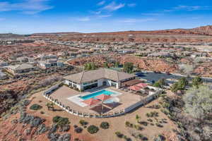 Aerial perspective of suburban area with a pool area and mountains