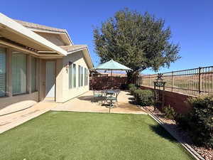 Fenced backyard with a patio