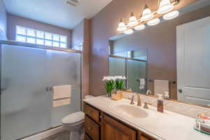 Full bathroom featuring vanity and a shower stall