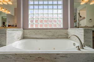 Full bathroom featuring a tub with jets