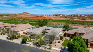 Aerial perspective of suburban area featuring mountains and a golf course
