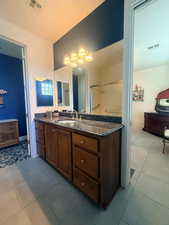 Full bathroom featuring vanity and light tile patterned floors