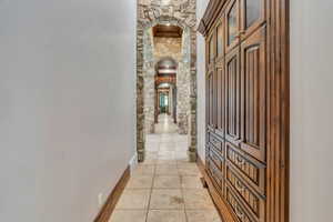 Hall with arched walkways and baseboards