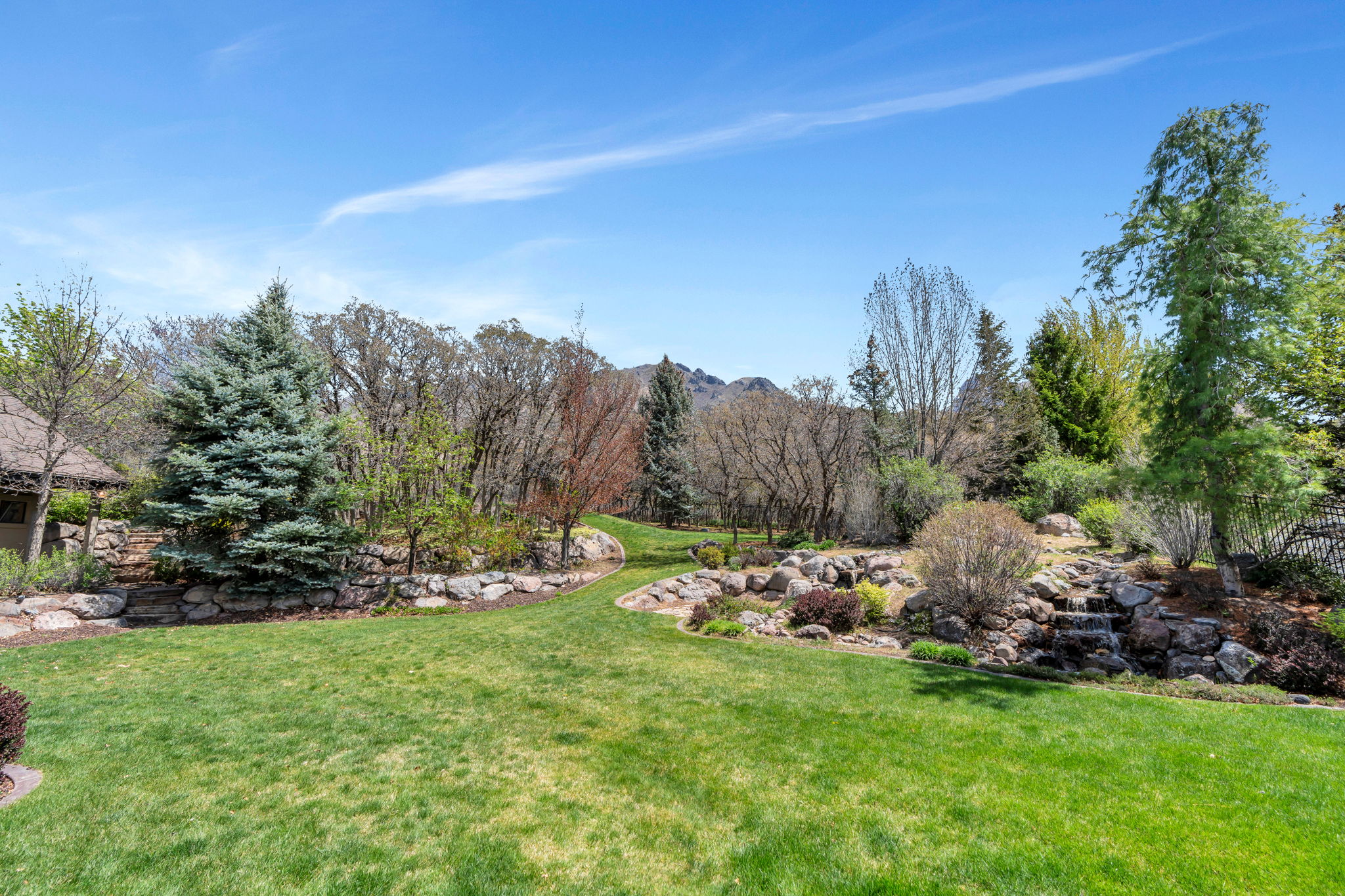 View of green lawn featuring a mountain view