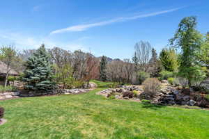 View of green lawn featuring a mountain view