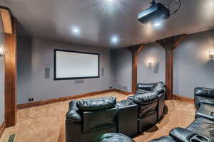 Cinema featuring light colored carpet, recessed lighting, and arched walkways