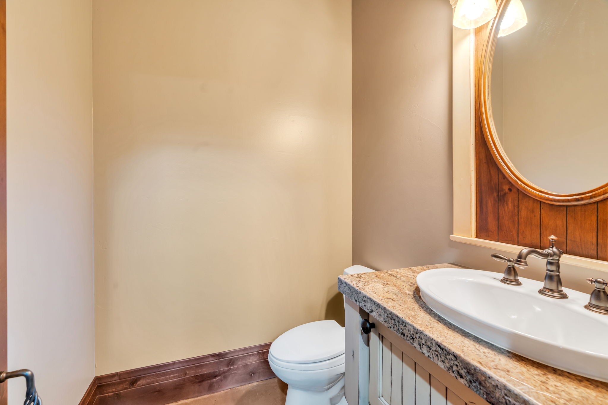 Half bathroom with vanity and toilet