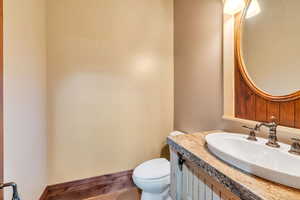 Half bathroom with vanity and toilet