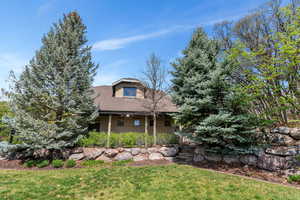 View of front of house with stucco siding and roof with shingles