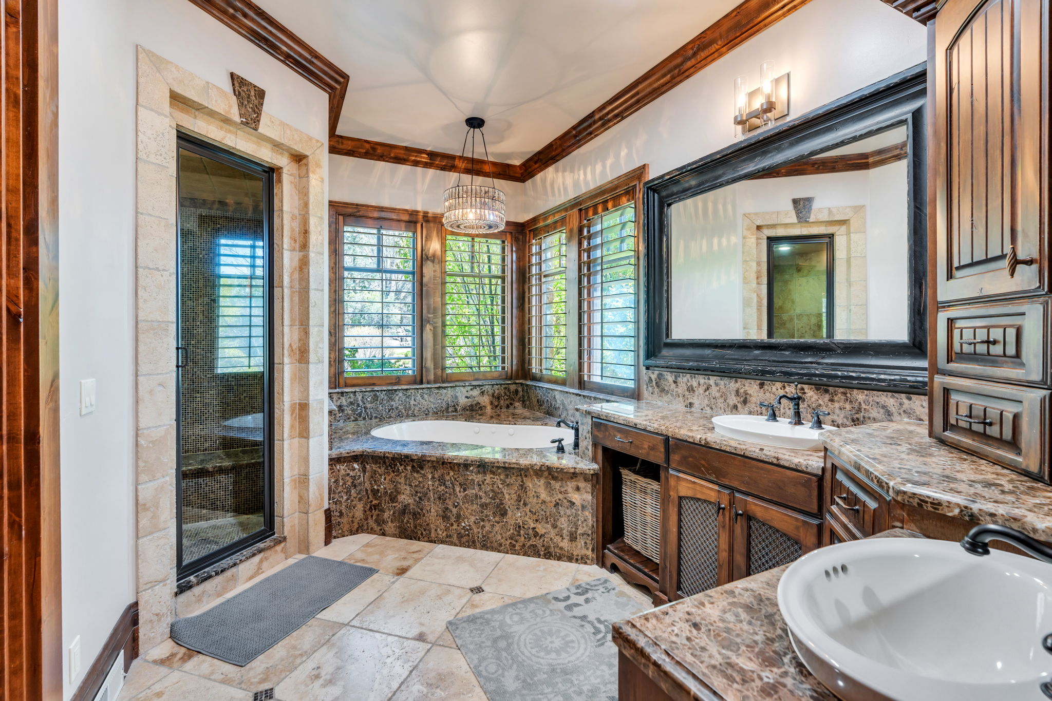 Full bathroom featuring vanity, a garden tub, a shower stall, crown molding, and light tile patterned floors