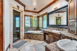 Full bathroom featuring vanity, a garden tub, a shower stall, crown molding, and light tile patterned floors