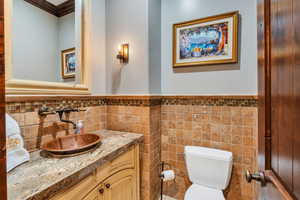 Bathroom with vanity and a wainscoted wall
