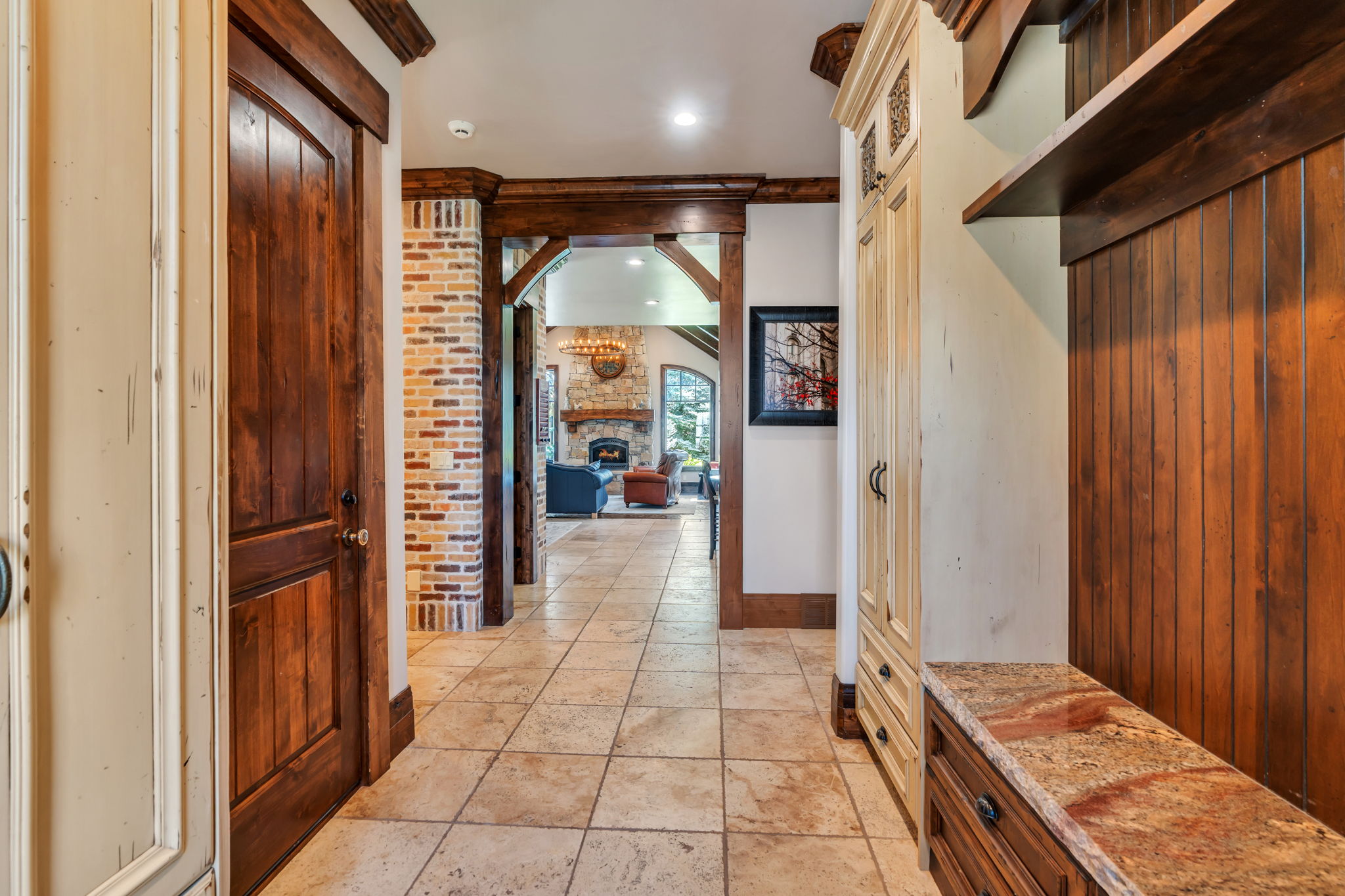 Hallway with stone tile floors and recessed lighting