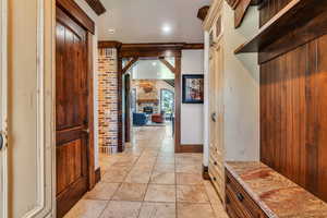 Hallway with stone tile floors and recessed lighting