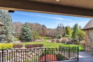 Patio / terrace with a mountain view and a yard