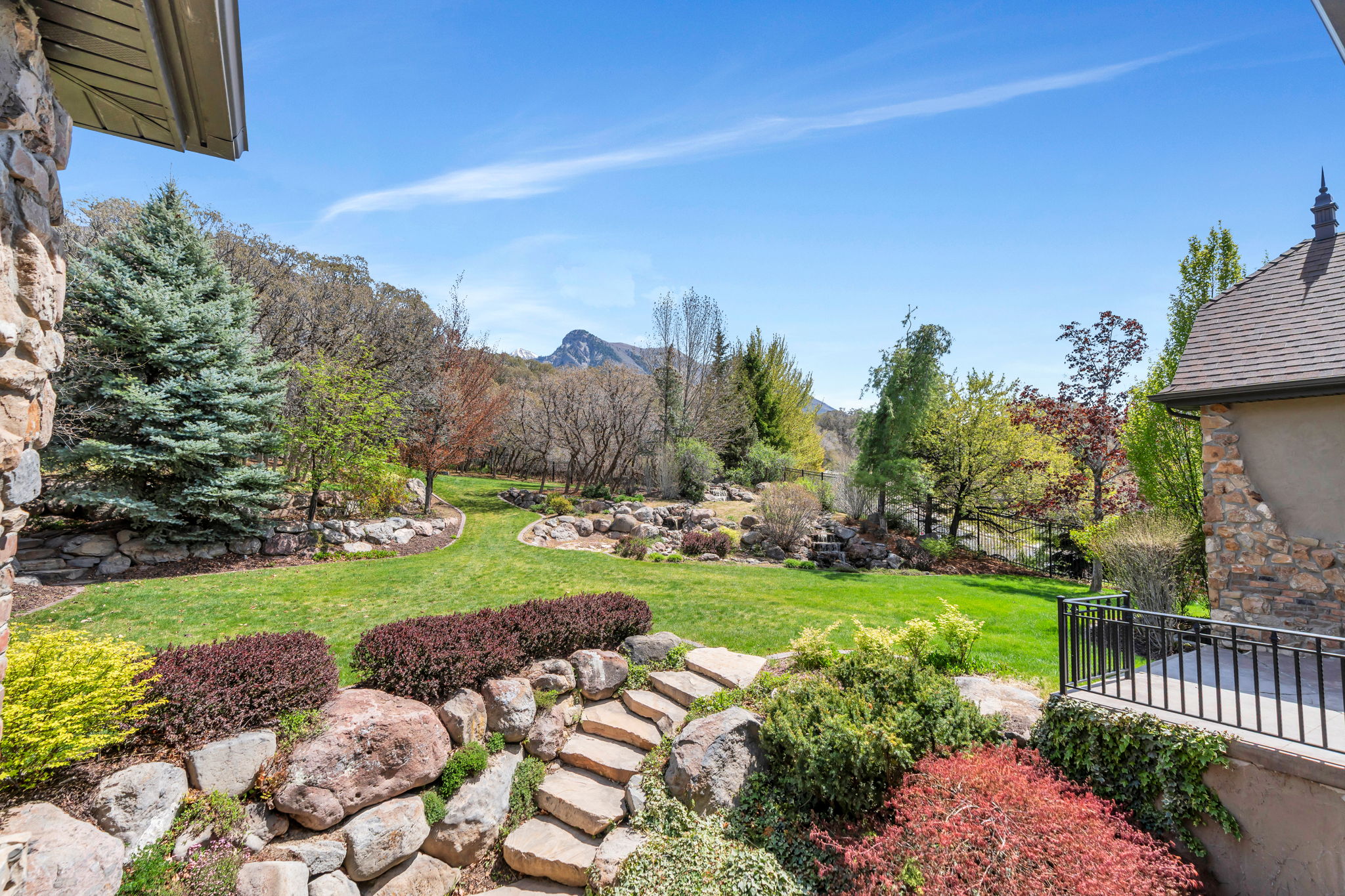 View of green lawn featuring a mountain view