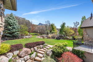 View of green lawn featuring a mountain view