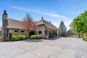 View of front of home featuring stone siding, stucco siding, concrete driveway, and a shingled roof