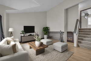 Living room featuring light wood-style floors and stairway