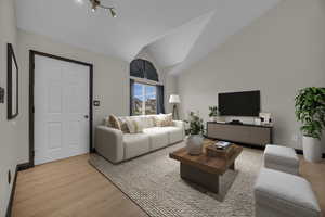 Living room featuring vaulted ceiling and light wood-type flooring