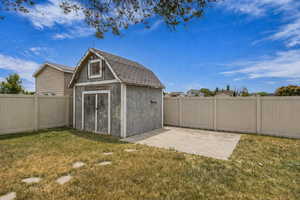View of shed with a fenced backyard